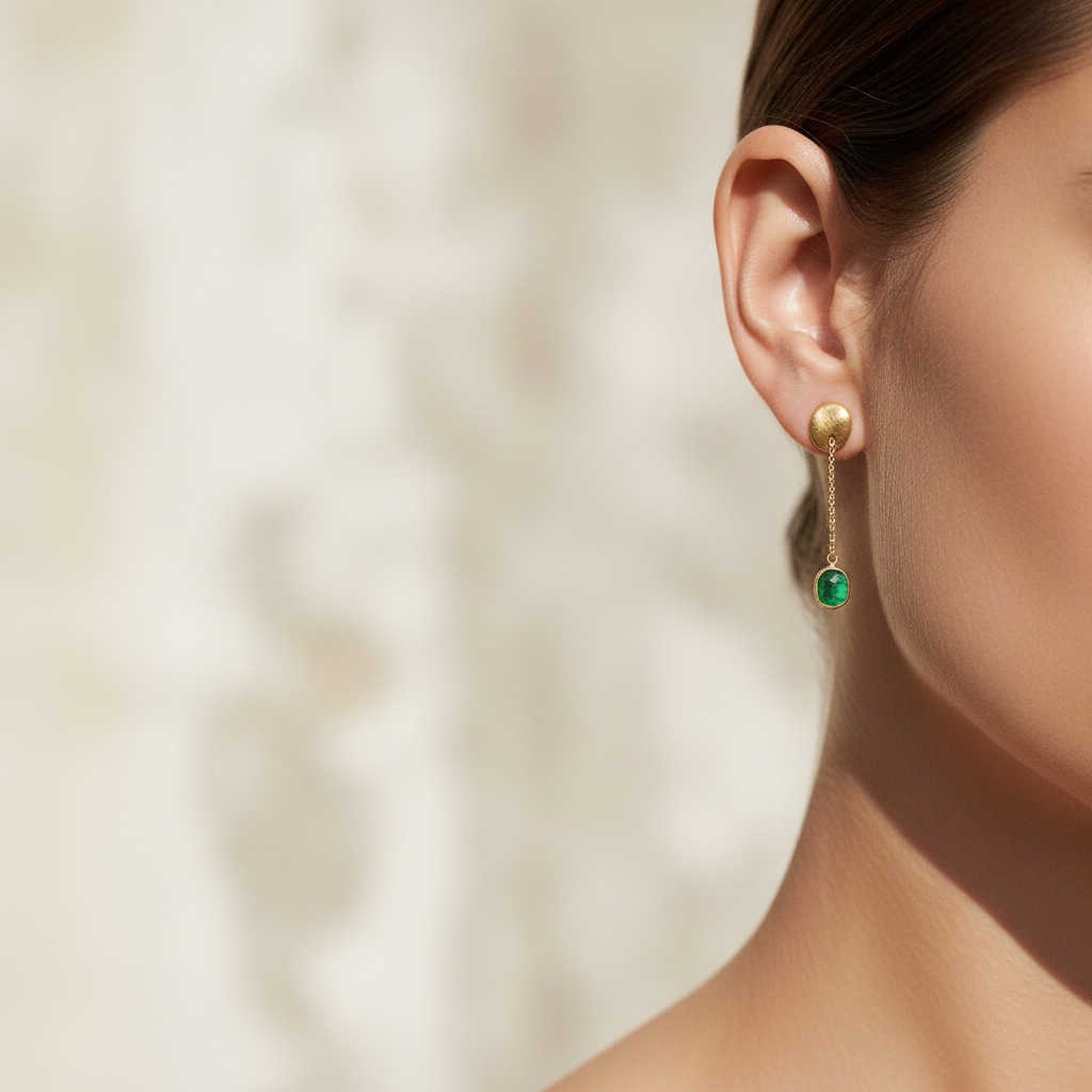 Cropped portrait wearing emerald studs